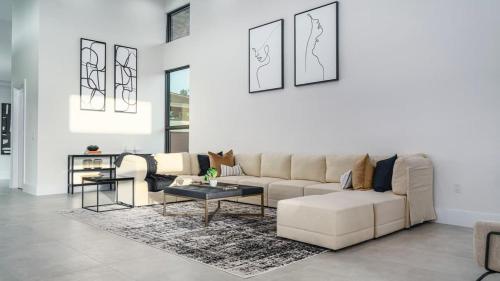 a living room with a couch and a table at The Mansion One and Only Luxurios 8 000 ft Villa in Melalevca Isles