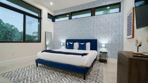 a bedroom with a king sized bed and a large window at The Mansion One and Only Luxurios 8 000 ft Villa in Melalevca Isles