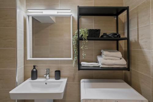 a bathroom with a sink and a mirror at Studio 6 in Bucharest