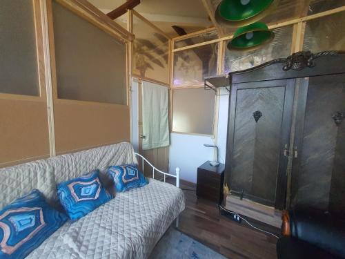 a living room with a couch and a tv at Baltā māja in Rīga