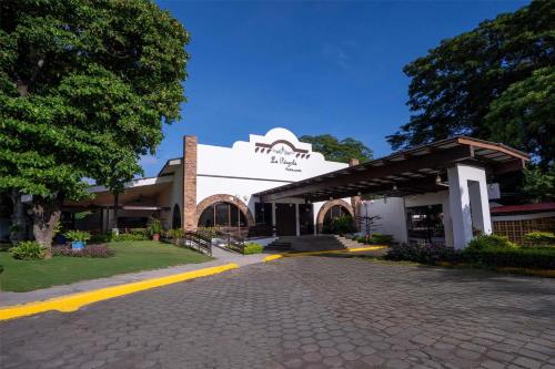 a building with a cobblestone street in front of it at Best Western Las Mercedes Airport in Managua