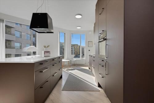 a kitchen with white counters and a large window at Spacious 2BR Apt with Balcony, Sauna and Free Parking in Reykjavík