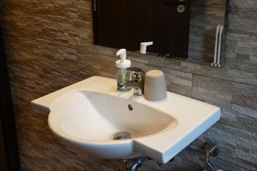 a white sink in a bathroom with a mirror at Haus Kärnten in Döbriach