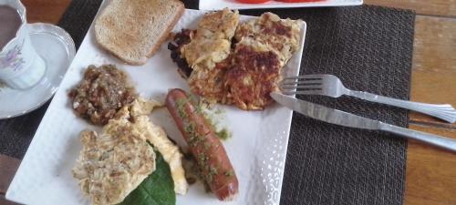 a plate of food with sausage and bread on a table at Luxury apartmеnt with private terrace in Altos del Maria in Sorá