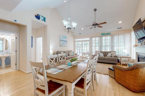 a dining room and living room with a table and chairs at Bear Trap Dunes - 51 Tulip Poplar in Ocean View