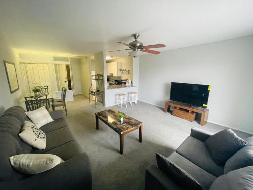 a living room with a couch and a flat screen tv at Pet-friendly 1br Condo Free Parking, Discount! in Cheltenham Village