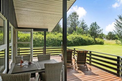 a patio with a table and chairs on a deck at JB139-Fjerritslev-Kastanievej-13 in Fjerritslev