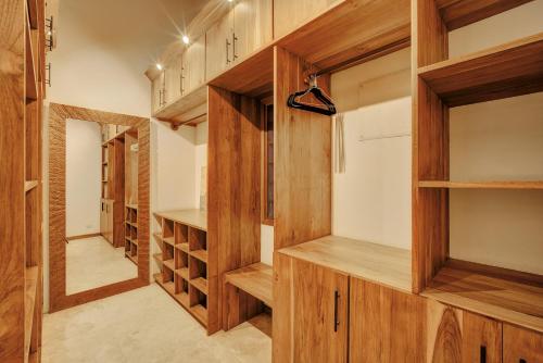 a wine cellar with wooden cabinets and shelves at ZEN Villa in Punta Uva