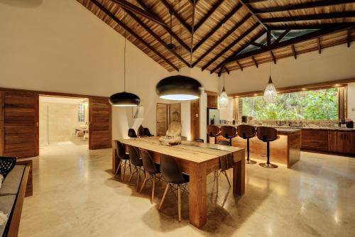 a dining room with a wooden table and chairs at ZEN Villa in Punta Uva