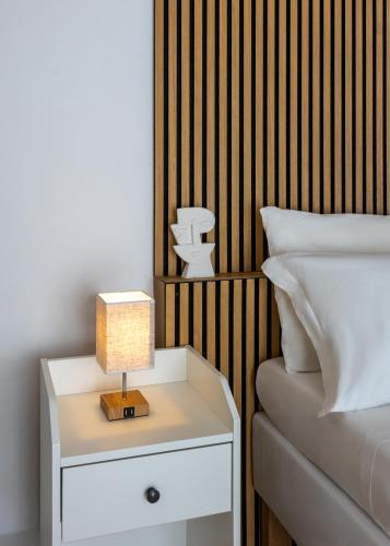 a nightstand with a lamp on it next to a bed at L'Altalena in Fiumicino