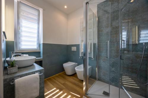 a bathroom with a shower and a toilet and a sink at L'Altalena in Fiumicino