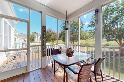 a screened in porch with a table and chairs at Bear Trap Dunes - 51 Tulip Poplar in Ocean View
