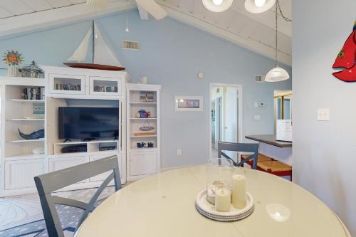 a dining room with a table and a tv at Chateau La Mer 1D in Destin