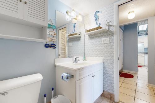 a white bathroom with a sink and a toilet at Chateau La Mer 1D in Destin