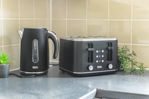 two toasters sitting on a counter next to a toaster at Rosewick Villa wt Office, Garden & Free Parking in Nottingham