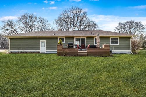 a house with a wooden deck in the yard at Rocky Gap Getaway in Benton Harbor