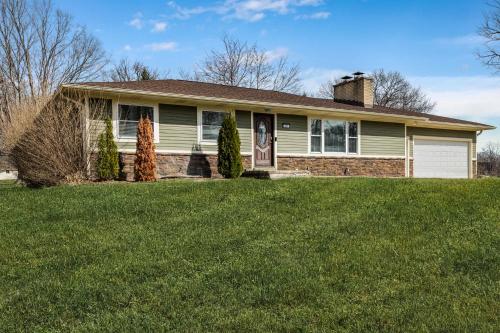 a house with a green lawn in front of it at Rocky Gap Getaway in Benton Harbor
