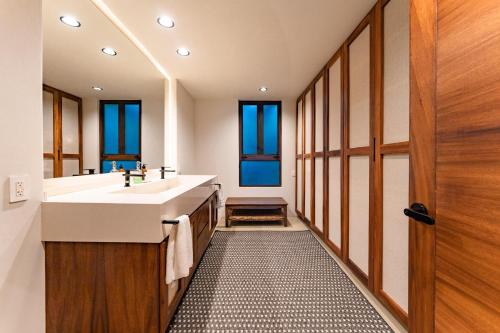 a bathroom with a sink and a large mirror at 3070 - La Cañada Villa H in Tangolunda
