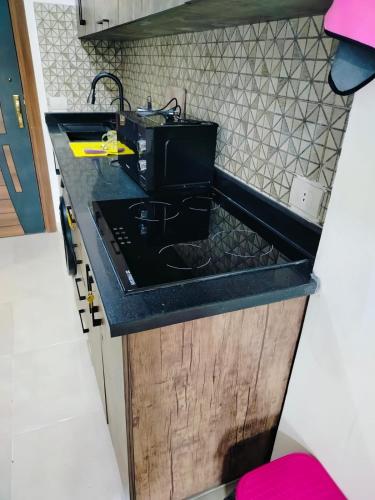 a kitchen with a black counter and a sink at Private Beach Chalet in Orabia in Hurghada