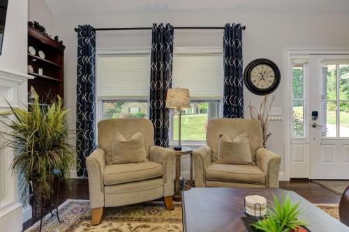a living room with two chairs and a clock at The Winchester House - Serene Surroundings + Close to Downtown Jasper in West Brook