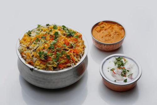 two bowls of food sitting on a white table at Collection O Hebbal Dasarahalli in Bengaluru