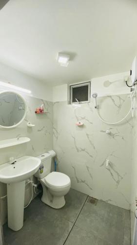 a bathroom with a toilet and a sink at "The Secret Hill" in Matara