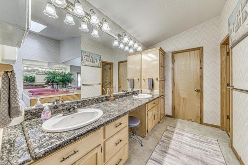 a bathroom with a sink and a large mirror at Hot Tub and Deck Home 1 Mi to Ruidoso River! in Ruidoso