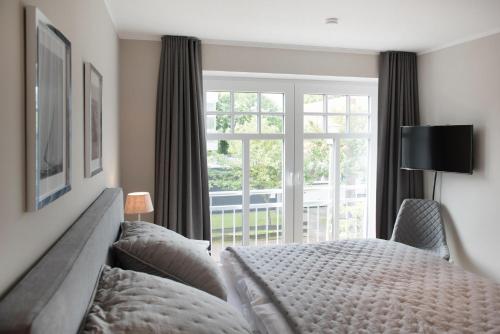 Postel nebo postele na pokoji v ubytování Lindenhof Landhaus 1 Meertied - Ferienwohnung im Lindenhof