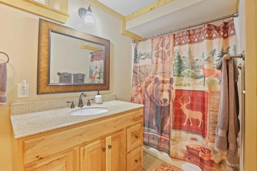 a bathroom with a sink and a shower curtain at 10-Acre Cabin, Sauna, Hot Tub, Game Rm, Stargazing Dome, EV, BBQ in Logan
