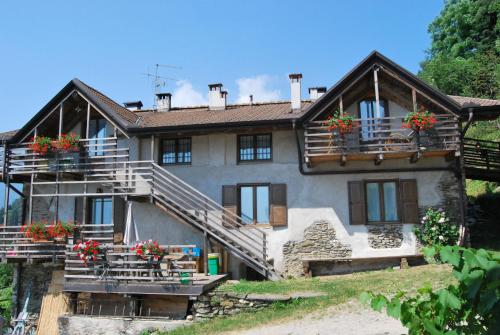 a house with flower boxes on the balconies of it at Maso Piatelle in Caldonazzo