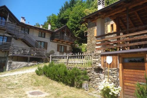 a house in the mountains with a fence at Maso Piatelle in Caldonazzo