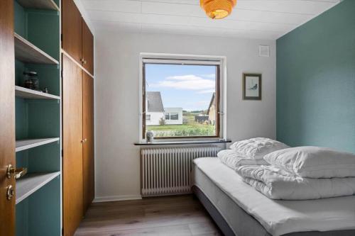 a bedroom with a bed and a window at JB244-Logstor-Aggersborgvej-51 in Løgstør