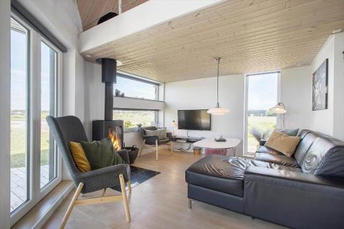 a living room with a couch and a fireplace at JB176-Brovst-Kronvildtvej-152 in Tranum