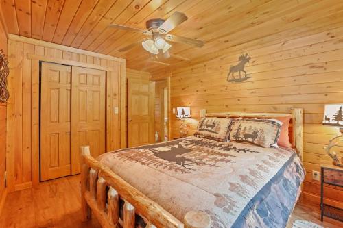 a bedroom with a bed in a log cabin at 10-Acre Cabin, Sauna, Hot Tub, Game Rm, Stargazing Dome, EV, BBQ in Logan