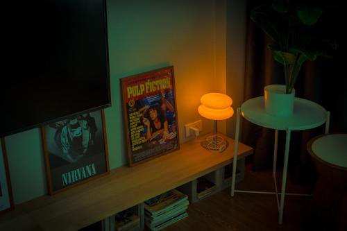 a room with a television and a table with a lamp at Into the town krabi in Krabi town