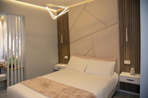 a bedroom with a bed with white sheets at The Three Diamonds - B&B CESENATICO in Cesenatico