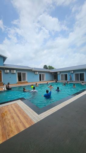 a group of people in a large swimming pool at Vrindaa- The Bliss Retreat in Karjat