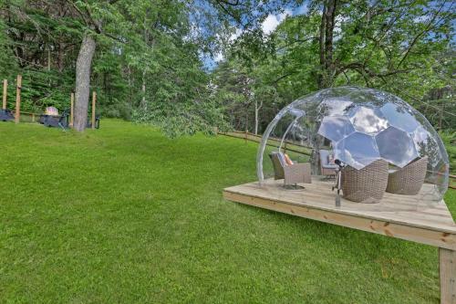a wooden deck with a soccer ball in a gazebo at 10-Acre Cabin, Sauna, Hot Tub, Game Rm, Stargazing Dome, EV, BBQ in Logan
