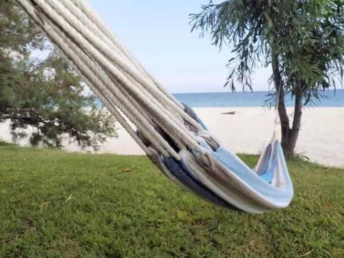 a hammock on the grass near a beach at Nina's house 4 a 300 mt dal mare in Santa Caterina Dello Ionio Marina