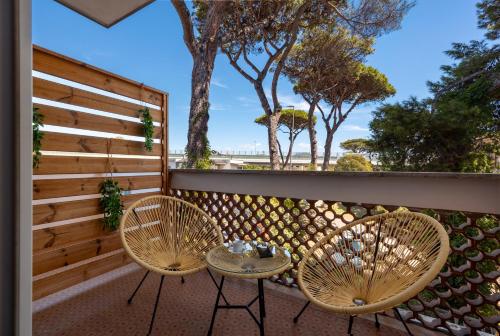 two chairs and a table on a balcony at L'Altalena in Fiumicino