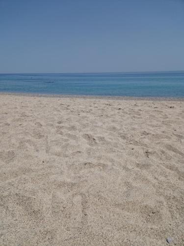 a sandy beach with the ocean in the background at Nina's house 5 a 300 mt dal mare in Santa Caterina Dello Ionio Marina