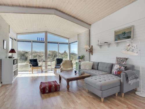 a living room with a couch and a table at Holiday Home Felis - 200m from the sea by Interhome in Saltum