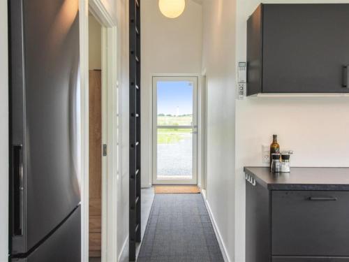 a kitchen with a counter and a window at Holiday Home Holke - 600m from the sea by Interhome in Hirtshals