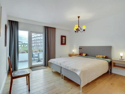 a bedroom with a large bed and a large window at Apartment Pekka - 50m from the sea by Interhome in Helsingør