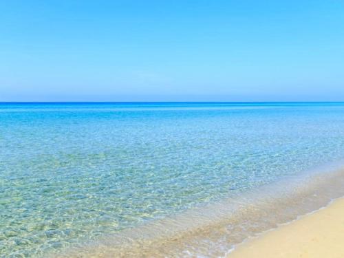 una playa de aguas cristalinas y una playa de arena en Home Summer, en Torre Pali