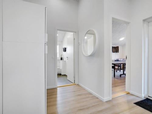 a hallway with a mirror and a dining room at Holiday Home Antina - 400m from the sea by Interhome in Hjørring