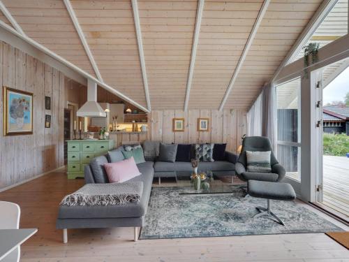 a living room with a couch and two chairs at Holiday Home Varpu - 1-6km from the sea by Interhome in Saltum