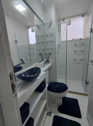 a bathroom with a sink and a toilet and a shower at Apartamento in Ananindeua