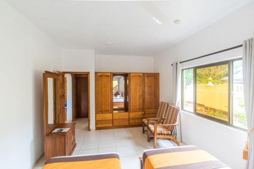 a room with two beds and a window at Kounous Self-Catering Apartments in La Réunion