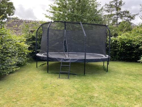 a trampoline in the grass in a yard at Holiday Home Elline - 450m from the sea by Interhome in Græsted